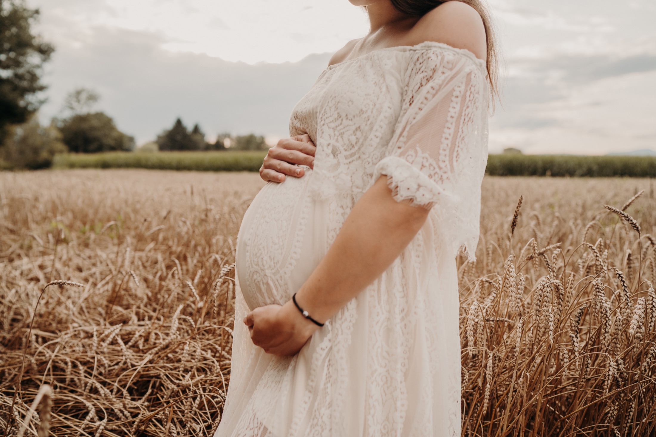 Babybauch einer werdenden Mama in einem weiten Feld